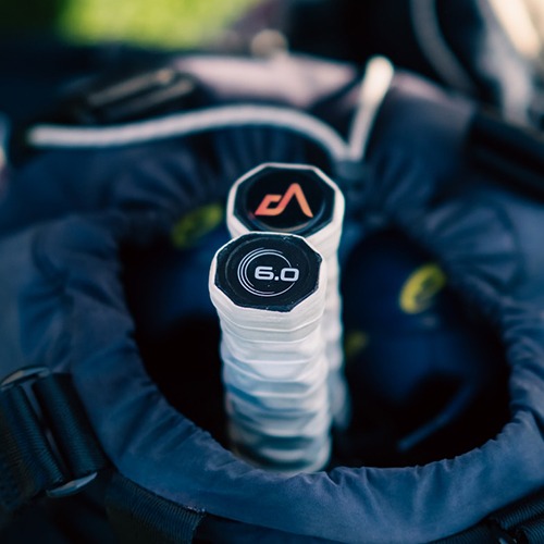Golf club grips are neatly arranged in a golf bag's opening, showcasing brands and specifications. Relevant for showcasing golf equipment details.