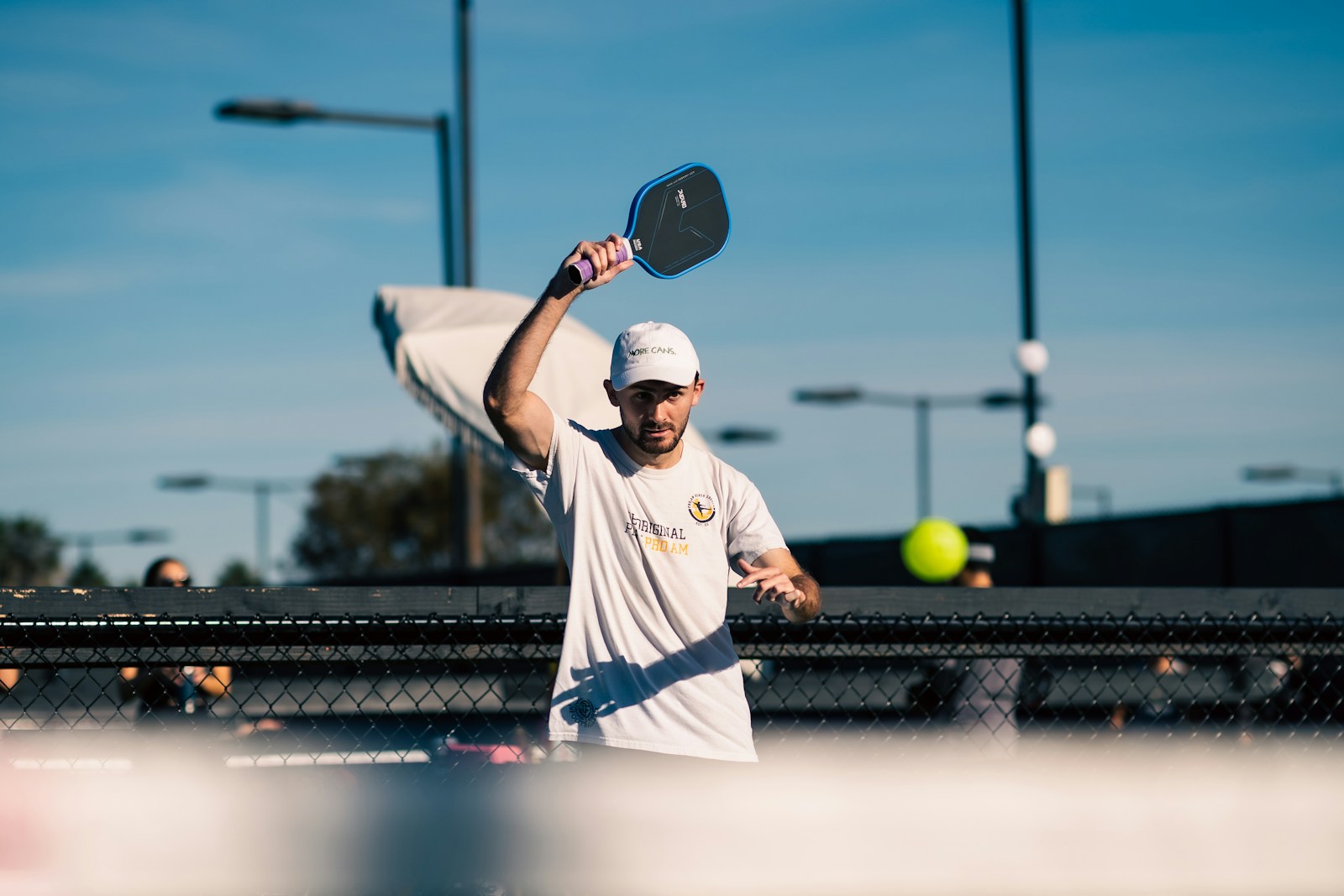A man holding a tennis racquet on top of a tennis court